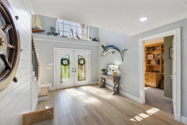 entrance foyer featuring french doors, light wood-style floors, crown molding, baseboards, and recessed lighting