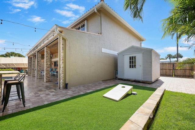 rear view of property with a patio area and stucco siding