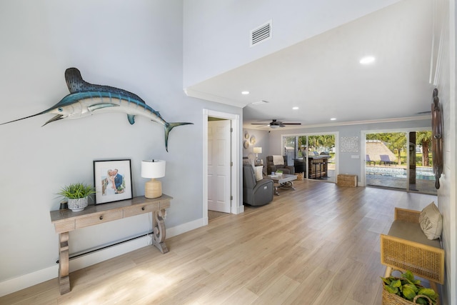living area with baseboards, light wood-style floors, recessed lighting, and crown molding