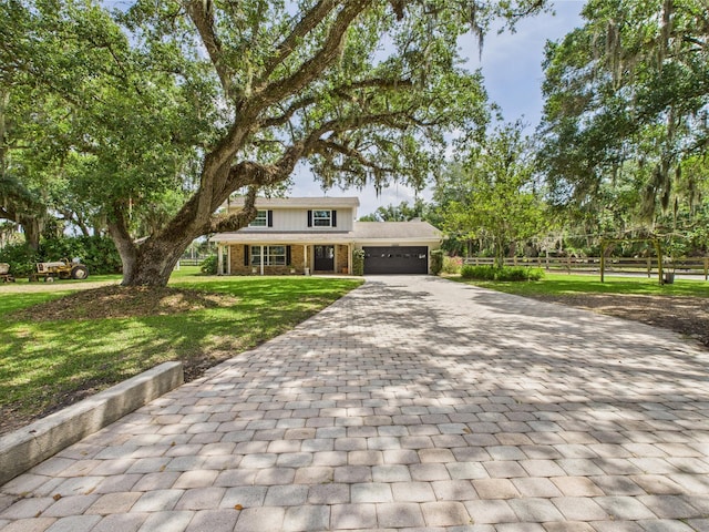 2045 SW 18th Ln, Okeechobee, FL 34974 - view of front of property featuring an attached garage, decorative driveway, brick siding, a front lawn, and a porch