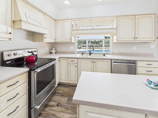 2045 SW 18th Ln, Okeechobee, FL 34974 - kitchen with appliances with stainless steel finishes, a sink, premium range hood, dark wood-style floors, and cream cabinets