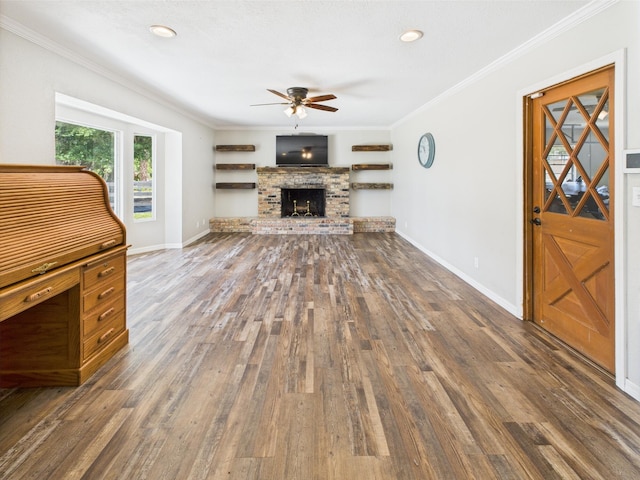 2045 SW 18th Ln, Okeechobee, FL 34974 - unfurnished living room featuring ceiling fan, wood finished floors, crown molding, a brick fireplace, and baseboards