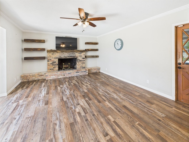 2045 SW 18th Ln, Okeechobee, FL 34974 - unfurnished living room featuring ornamental molding, ceiling fan, wood finished floors, baseboards, and a brick fireplace