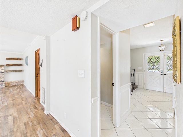 2045 SW 18th Ln, Okeechobee, FL 34974 - hallway with a textured ceiling, baseboards, and light wood-type flooring