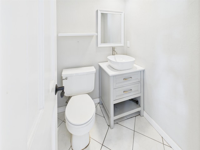 2045 SW 18th Ln, Okeechobee, FL 34974 - half bathroom with toilet, vanity, baseboards, and tile patterned floors