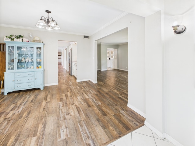 2045 SW 18th Ln, Okeechobee, FL 34974 - unfurnished dining area with a chandelier, wood finished floors, ornamental molding, and baseboards