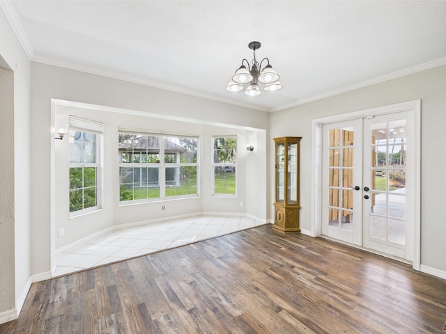 2045 SW 18th Ln, Okeechobee, FL 34974 - unfurnished dining area featuring wood finished floors, french doors, a chandelier, ornamental molding, and baseboards