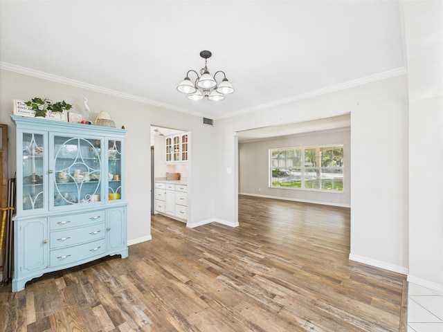 2045 SW 18th Ln, Okeechobee, FL 34974 - empty room with a chandelier, ornamental molding, wood finished floors, and baseboards