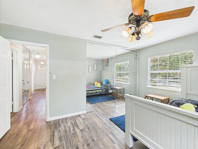 2045 SW 18th Ln, Okeechobee, FL 34974 - bedroom with wood finished floors, a closet, baseboards, and a ceiling fan