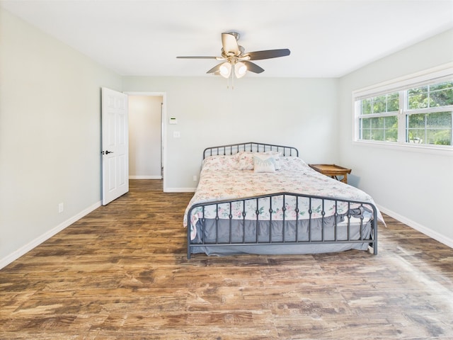 2045 SW 18th Ln, Okeechobee, FL 34974 - bedroom featuring baseboards, wood finished floors, and a ceiling fan
