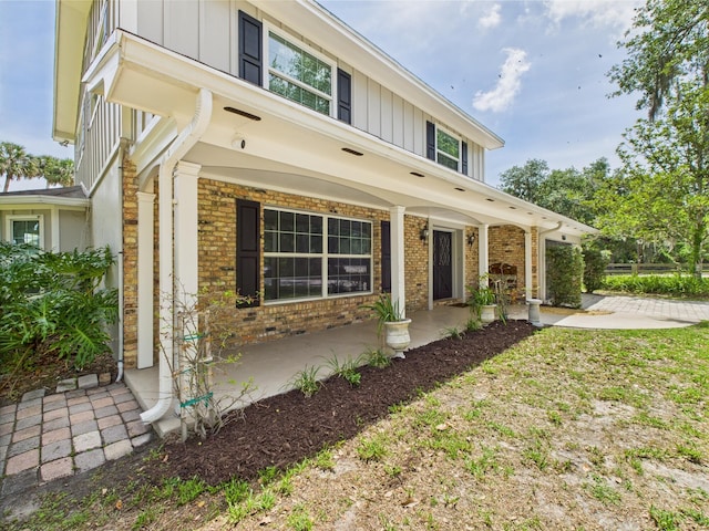 2045 SW 18th Ln, Okeechobee, FL 34974 - view of front of house featuring board and batten siding, brick siding, and a porch