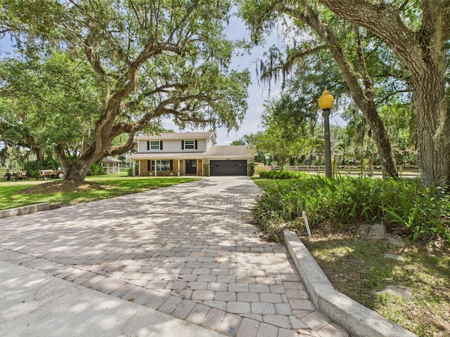 2045 SW 18th Ln, Okeechobee, FL 34974 - traditional-style home with decorative driveway, a garage, a front yard, and brick siding