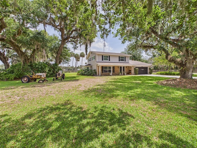 2045 SW 18th Ln, Okeechobee, FL 34974 - back of house with brick siding, a garage, a yard, and asphalt driveway