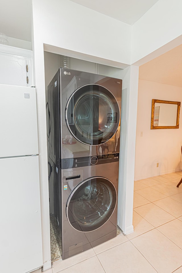 517 SE Crooked Lake Ln Unit D, Fort Pierce, FL 34982 - laundry area with stacked washing machine and dryer and tile patterned flooring