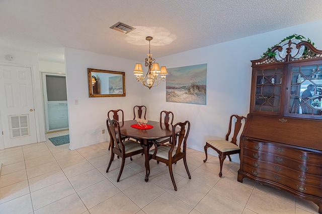 517 SE Crooked Lake Ln Unit D, Fort Pierce, FL 34982 - dining room featuring a chandelier, light tile patterned floors, and a textured ceiling