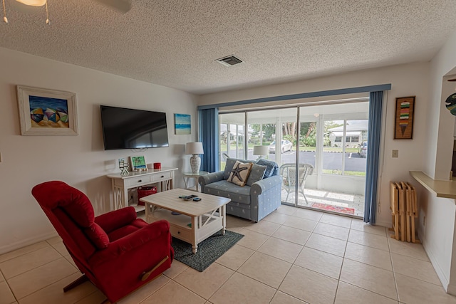 517 SE Crooked Lake Ln Unit D, Fort Pierce, FL 34982 - living area featuring light tile patterned flooring, a textured ceiling, and radiator heating unit