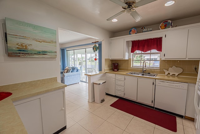 517 SE Crooked Lake Ln Unit D, Fort Pierce, FL 34982 - kitchen featuring dishwasher, a sink, white cabinetry, light countertops, and recessed lighting