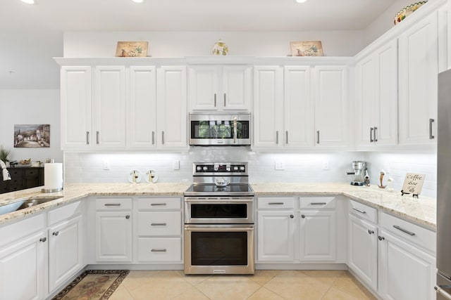 10171 SW Dolce Rd, Port Saint Lucie, FL 34986 - kitchen featuring stainless steel appliances, decorative backsplash, white cabinets, and recessed lighting