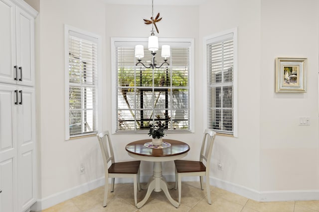 10171 SW Dolce Rd, Port Saint Lucie, FL 34986 - dining room with a chandelier, baseboards, and light tile patterned floors