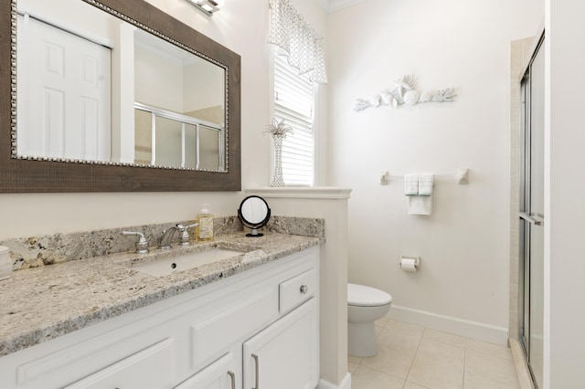 10171 SW Dolce Rd, Port Saint Lucie, FL 34986 - bathroom with a stall shower, toilet, baseboards, vanity, and tile patterned flooring