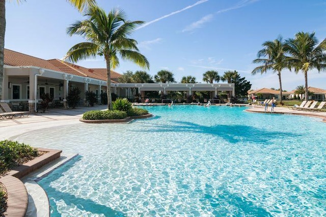 10171 SW Dolce Rd, Port Saint Lucie, FL 34986 - community pool featuring ceiling fan and a patio area