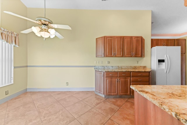 8586 Brian Blvd, Boynton Beach, FL 33472 - kitchen featuring white refrigerator with ice dispenser, a ceiling fan, baseboards, light tile patterned flooring, and light stone countertops