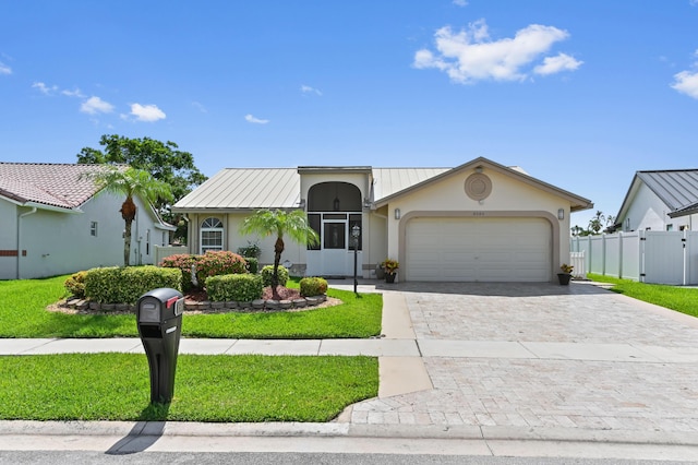 8586 Brian Blvd, Boynton Beach, FL 33472 - view of front of property with decorative driveway, stucco siding, and a garage