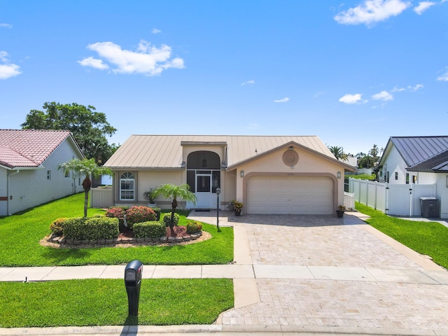 8586 Brian Blvd, Boynton Beach, FL 33472 - view of front of property with stucco siding, decorative driveway, a standing seam roof, and an attached garage