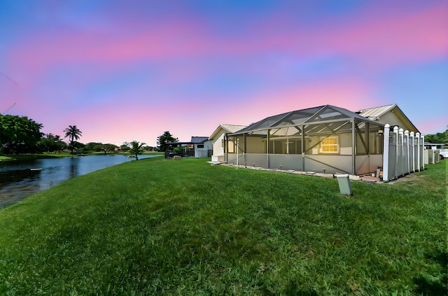 8586 Brian Blvd, Boynton Beach, FL 33472 - yard at dusk featuring a water view, a yard, and a lanai