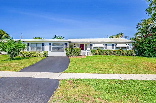 1328 SE 3rd Ave, Deerfield Beach, FL 33441 - view of front facade with a front lawn, asphalt driveway, and stucco siding