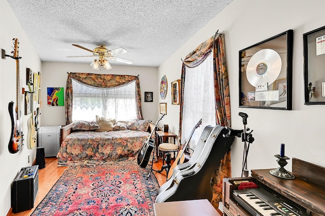 1328 SE 3rd Ave, Deerfield Beach, FL 33441 - bedroom featuring light wood finished floors, a textured ceiling, and a ceiling fan
