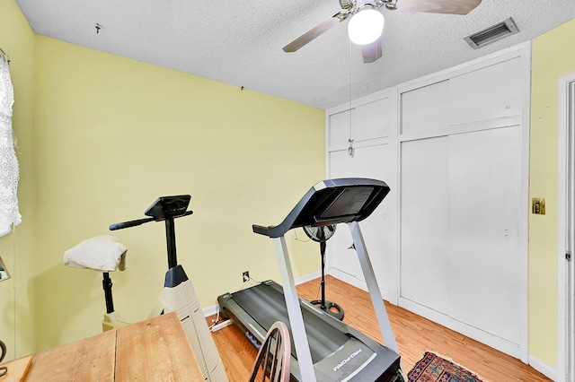 1328 SE 3rd Ave, Deerfield Beach, FL 33441 - exercise room with wood finished floors, ceiling fan, and a textured ceiling
