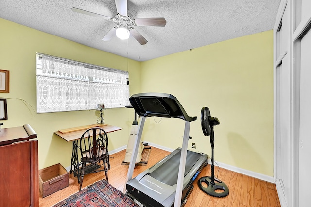 1328 SE 3rd Ave, Deerfield Beach, FL 33441 - exercise area with a textured ceiling, ceiling fan, wood finished floors, and baseboards