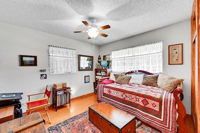 1328 SE 3rd Ave, Deerfield Beach, FL 33441 - bedroom with light wood-style floors, a textured ceiling, baseboards, and a ceiling fan