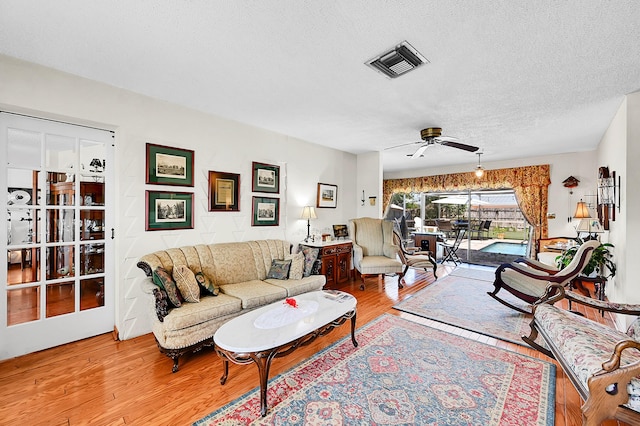 1328 SE 3rd Ave, Deerfield Beach, FL 33441 - living area with light wood-style floors, ceiling fan, and a textured ceiling