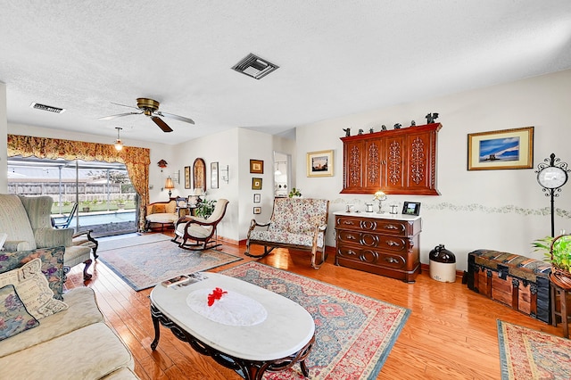 1328 SE 3rd Ave, Deerfield Beach, FL 33441 - living area with ceiling fan, light wood-type flooring, and a textured ceiling