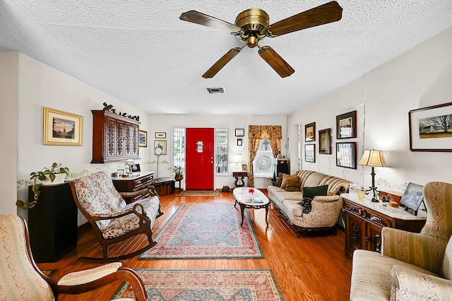1328 SE 3rd Ave, Deerfield Beach, FL 33441 - living area featuring ceiling fan, wood finished floors, and a textured ceiling