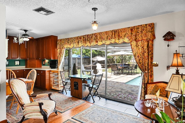 1328 SE 3rd Ave, Deerfield Beach, FL 33441 - kitchen featuring a textured ceiling, light countertops, and decorative light fixtures