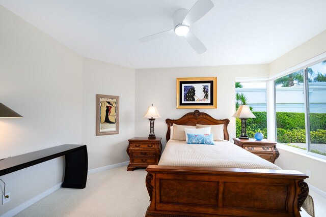 6051 NW 24th Ter, Boca Raton, FL 33496 - bedroom with carpet floors, multiple windows, baseboards, and ceiling fan