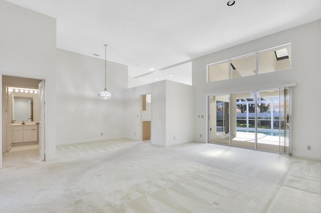 135 Eagleton Ct, Palm Beach Gardens, FL 33418 - unfurnished room featuring a towering ceiling, carpet, baseboards, and recessed lighting