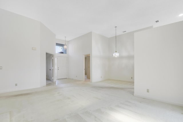 135 Eagleton Ct, Palm Beach Gardens, FL 33418 - empty room featuring light carpet, a towering ceiling, and baseboards