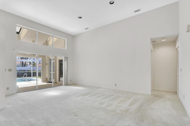 135 Eagleton Ct, Palm Beach Gardens, FL 33418 - empty room with carpet floors, baseboards, and a towering ceiling