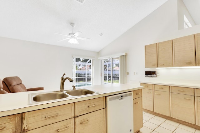 135 Eagleton Ct, Palm Beach Gardens, FL 33418 - kitchen with dishwasher, light brown cabinetry, vaulted ceiling, a sink, and a textured ceiling
