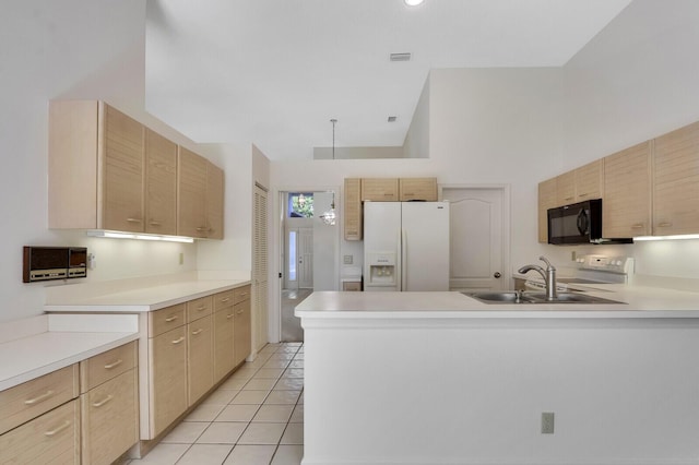 135 Eagleton Ct, Palm Beach Gardens, FL 33418 - kitchen with white refrigerator with ice dispenser, light brown cabinetry, black microwave, and a sink