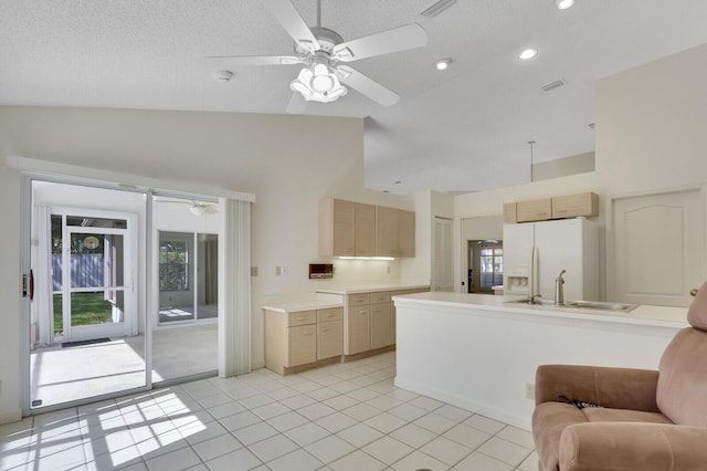 135 Eagleton Ct, Palm Beach Gardens, FL 33418 - kitchen with white refrigerator with ice dispenser, a sink, ceiling fan, light brown cabinetry, and high vaulted ceiling