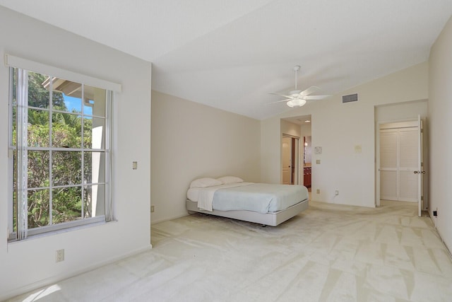 135 Eagleton Ct, Palm Beach Gardens, FL 33418 - bedroom with light colored carpet, vaulted ceiling, ensuite bathroom, and ceiling fan