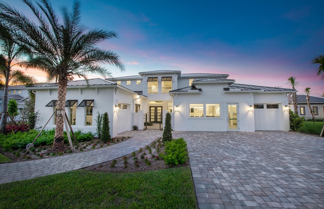 20132 Se Bridgewater Drive Madeira Model, Jupiter, FL 33458 - view of front of home with a standing seam roof, a garage, stucco siding, decorative driveway, and metal roof
