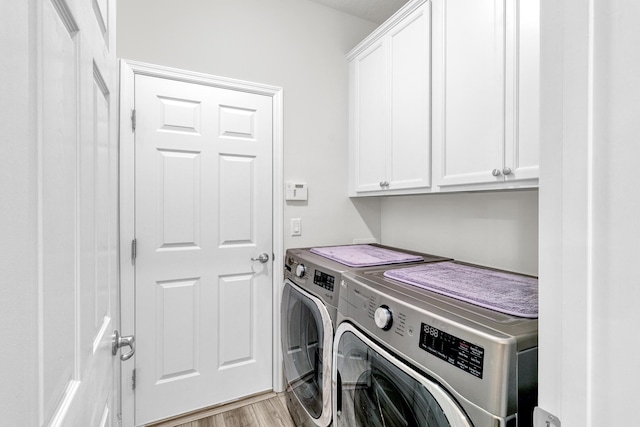 6020 Wild Olive Way, Vero Beach, FL 32966 - laundry room featuring washer and clothes dryer, cabinet space, and light wood-style floors