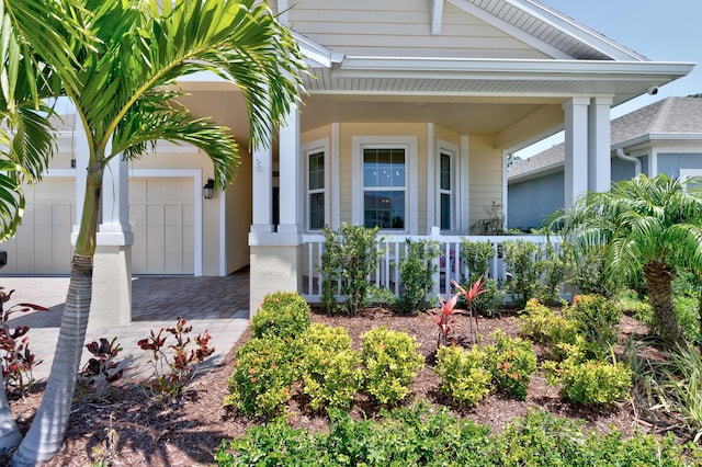 6020 Wild Olive Way, Vero Beach, FL 32966 - view of front of property with a porch, decorative driveway, and an attached garage