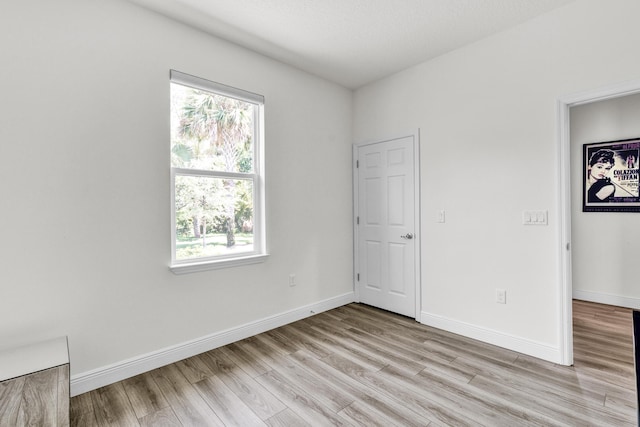 6020 Wild Olive Way, Vero Beach, FL 32966 - unfurnished bedroom with light wood finished floors and baseboards